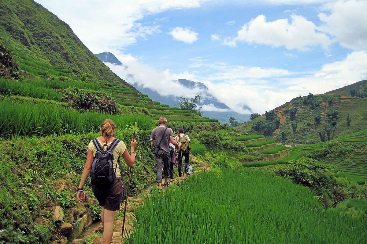 Happy travelers enjoying sunset over terraced fields in northern Vietnam