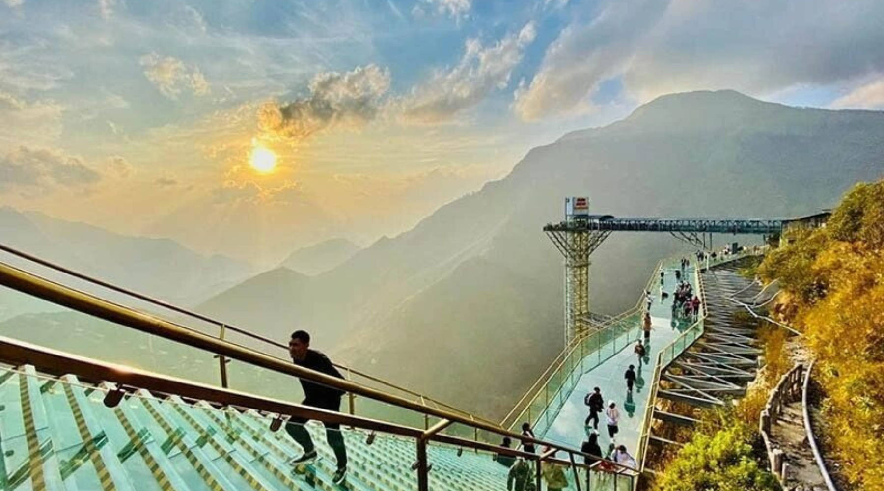 Walking on the glass bridge above a sea of clouds