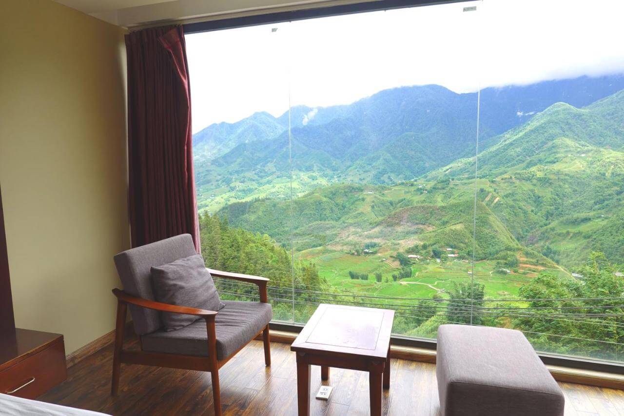 Mountain-view hotel room with balcony in a highland town