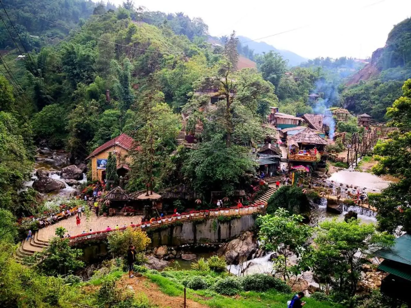 Travelers walking down Cat Cat Road from Sapa Town