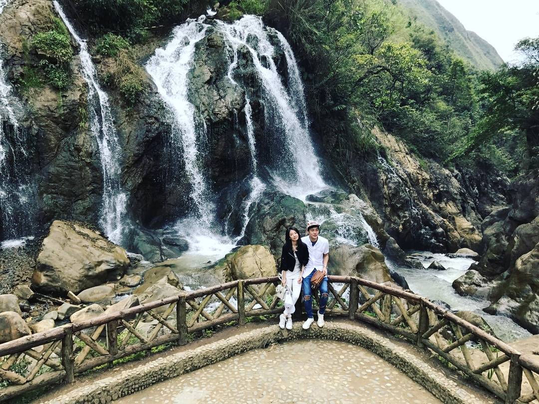 Hidden waterfall in Sapa surrounded by lush forest