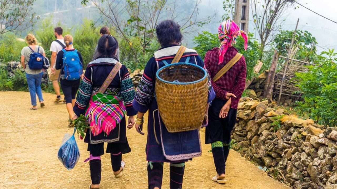 Local guide leading visitors through a traditional village in Sapa