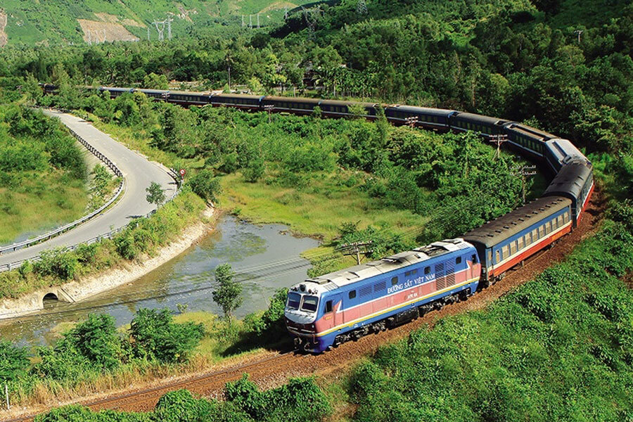 Long distance train passing through rural landscapes in northern Vietnam