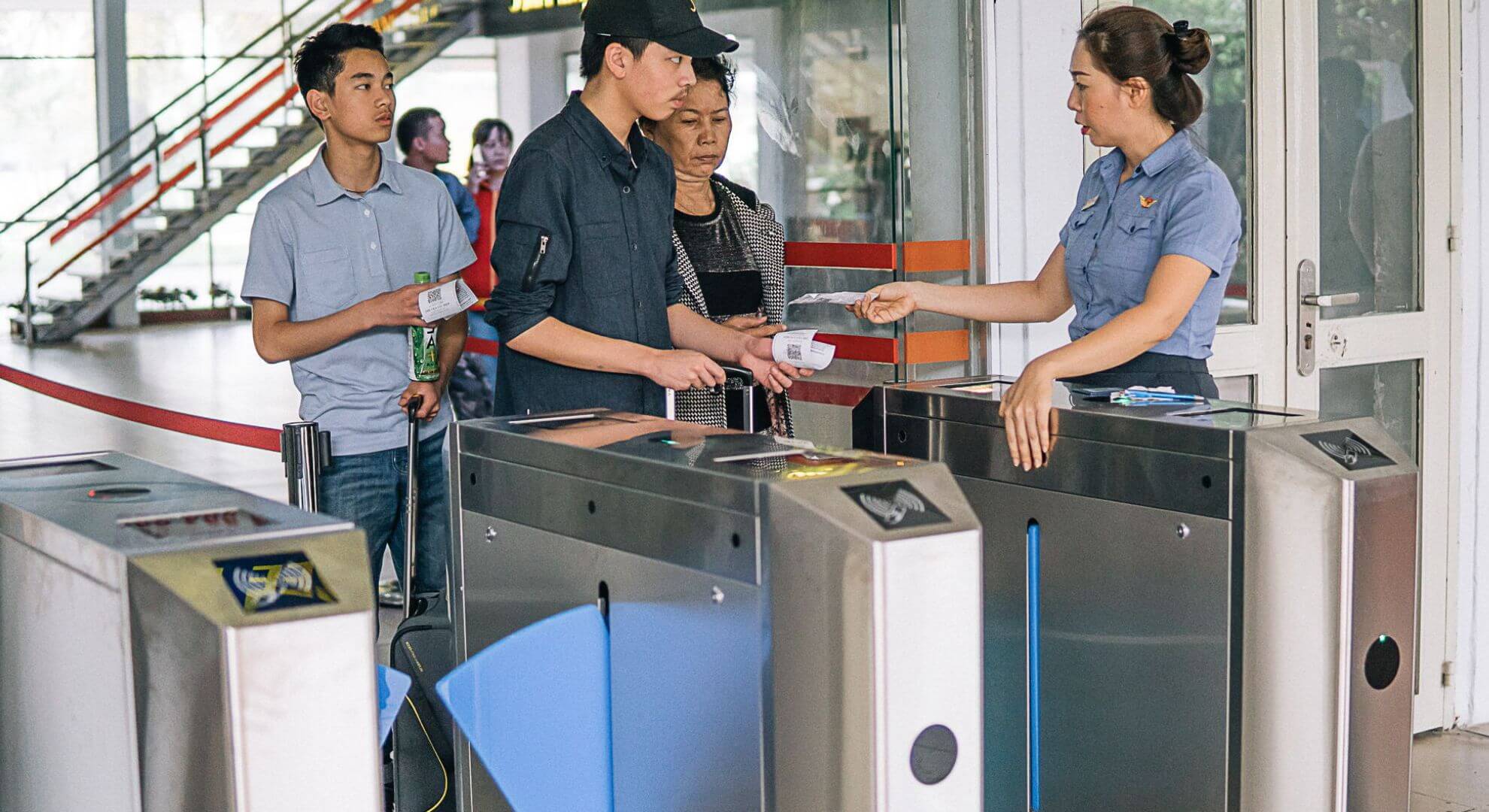 Passengers booking train tickets at a railway station counter
