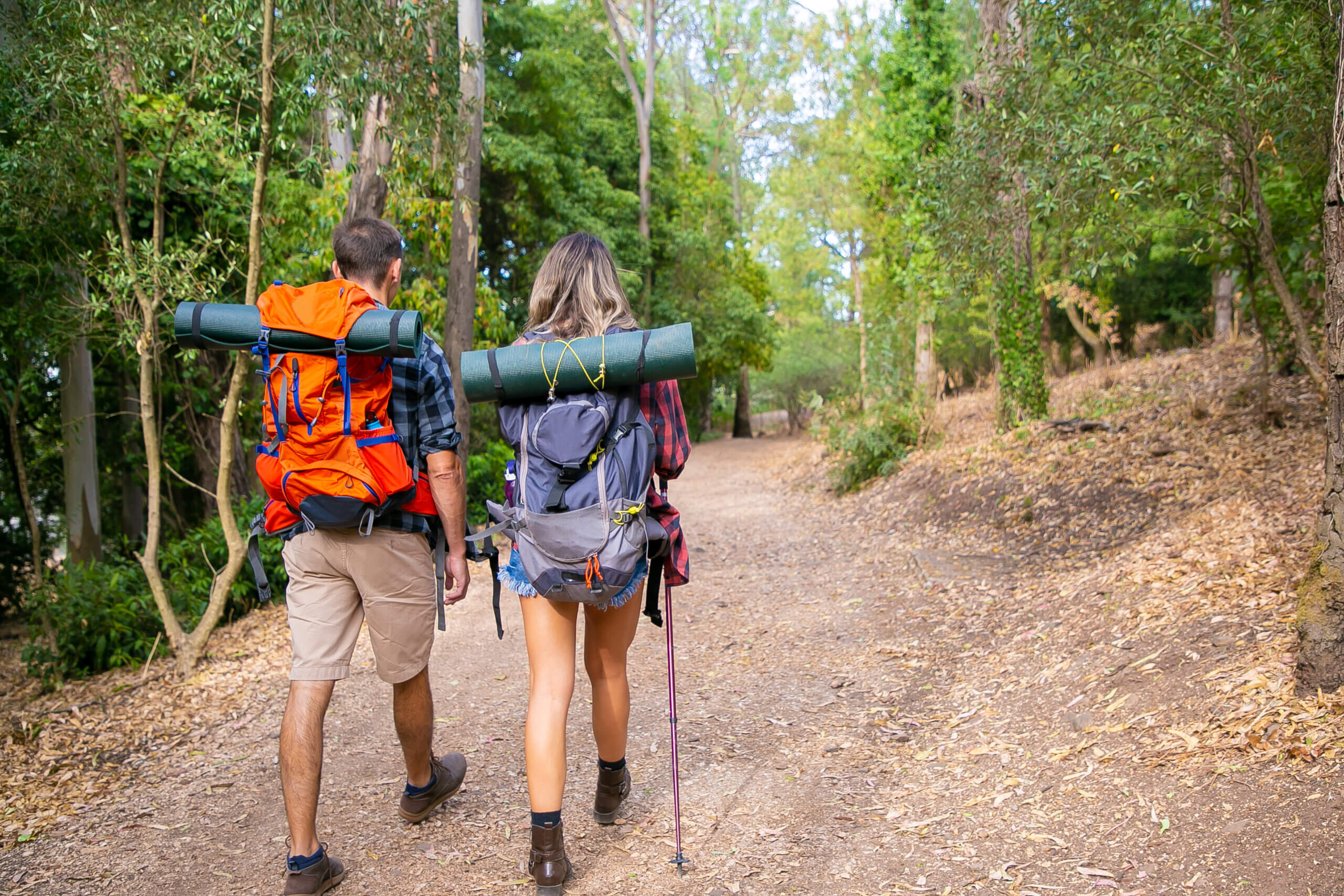 Traveler carrying backpack and camera while trekking in the mountains