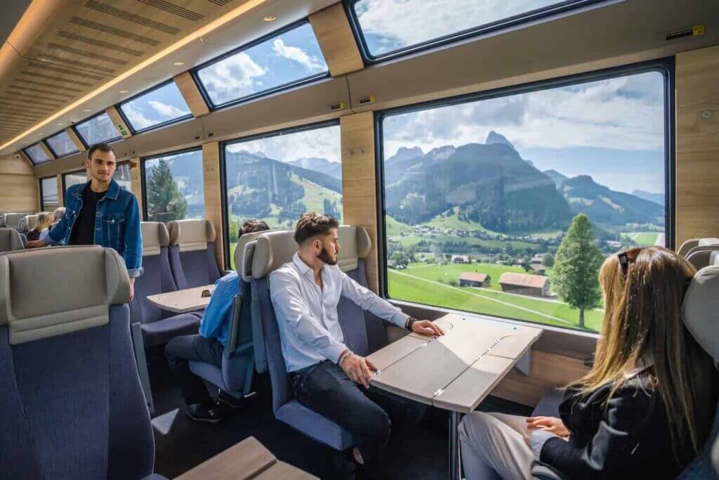 traveler taking photos from the window of a scenic train