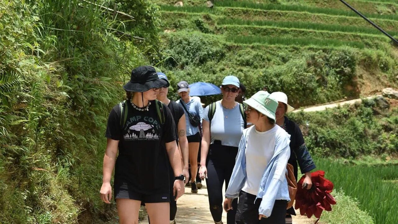 Trekking through rice terraces between villages in Muong Hoa Valley
